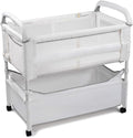 Arm’s Reach Clear-Vue Co-Sleeper Bedside Bassinet Featuring Clear Mesh Panels with Fold-Down Side, Large Attached Storage Basket, 4 Wheels, and Height-Adjustable Legs, White